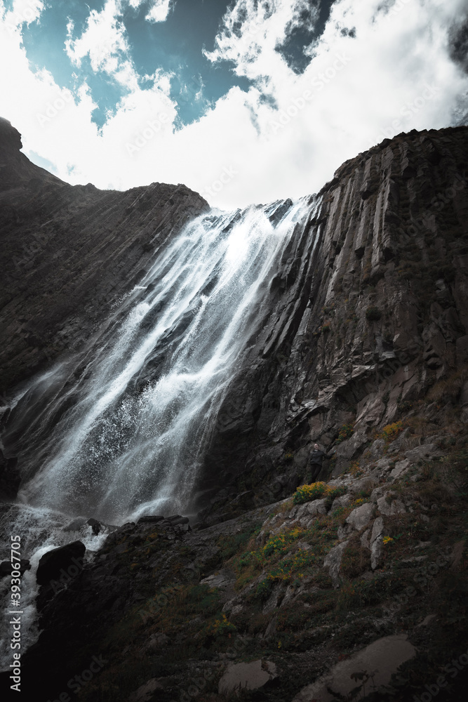 waterfall terskol on a volcanic rock