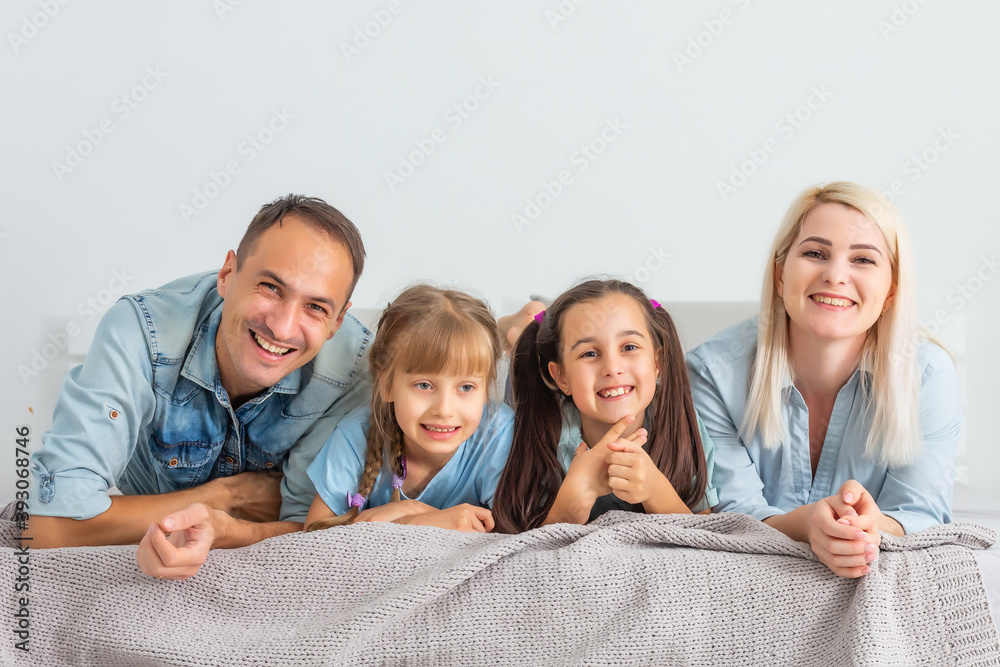 Happy family with children in bed