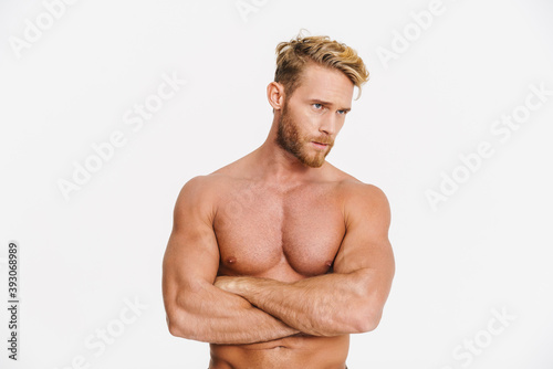 Handsome caucasian shirtless man posing with arms crossed