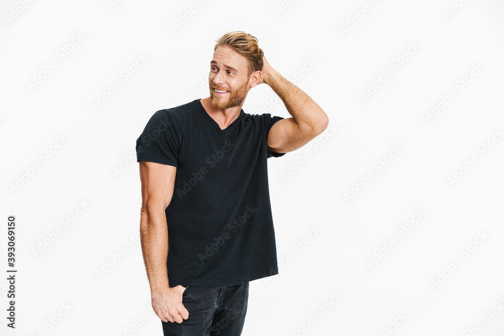Pleased caucasian blonde man posing and smiling at camera Pleased caucasian blonde man posing and smiling at camera