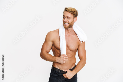 Happy caucasian shirtless man posing with towel and smiling