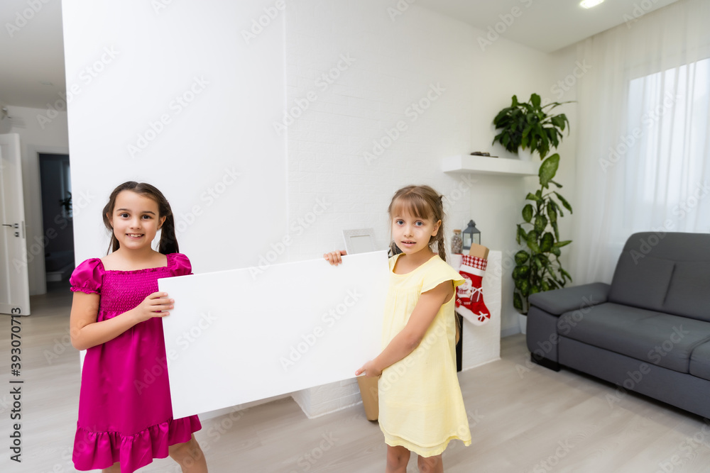 two little girls standing with empty horizontal banner in hands, a photo canvas two little girls standing with empty horizontal banner in hands, a photo canvas