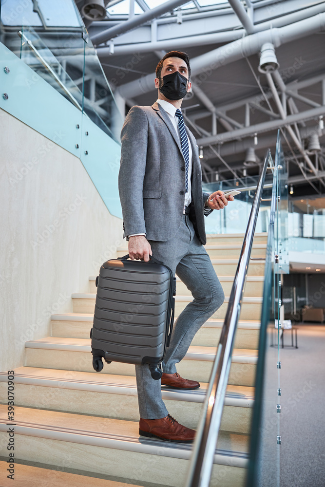 Business professional stopping on in the middle of the stairs Business professional stopping on in the middle of the stairs