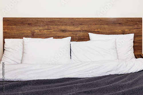 Fototapeta Naklejka Na Ścianę i Meble -  Modern bedroom interior. Bed with wooden headboard