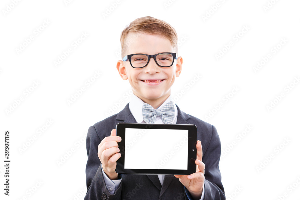 Small schoolboy standing with tablet against white Small schoolboy standing with tablet against white