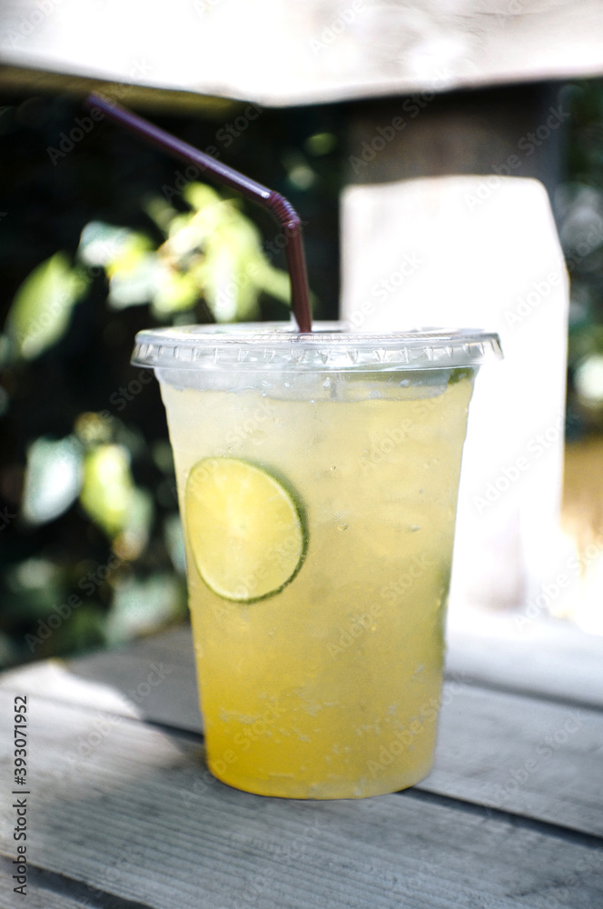 Lemon and honey soda in a glass are placed on the table. Lemon and honey soda in a glass are placed on the table.