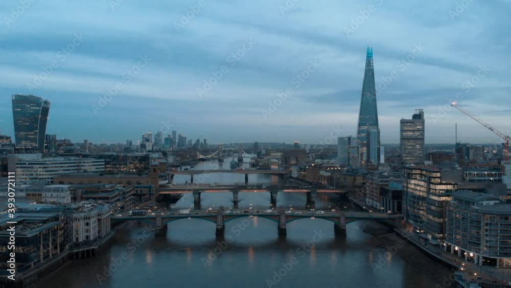 Dolly forward drone shot over the Thames London towards the shard and Canary Wharf at blue hour Dolly forward drone shot over the Thames London towards the shard and Canary Wharf at blue hour
