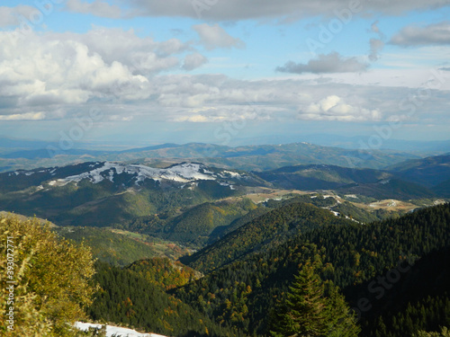 Landscape of the Kopaonik mountain range under the sunlight and a blue cloudy sky in Serbia photo