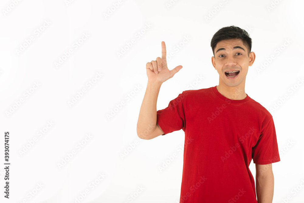 red t-shirt man pointing his finger to copyspace red t-shirt man pointing his finger to copyspace