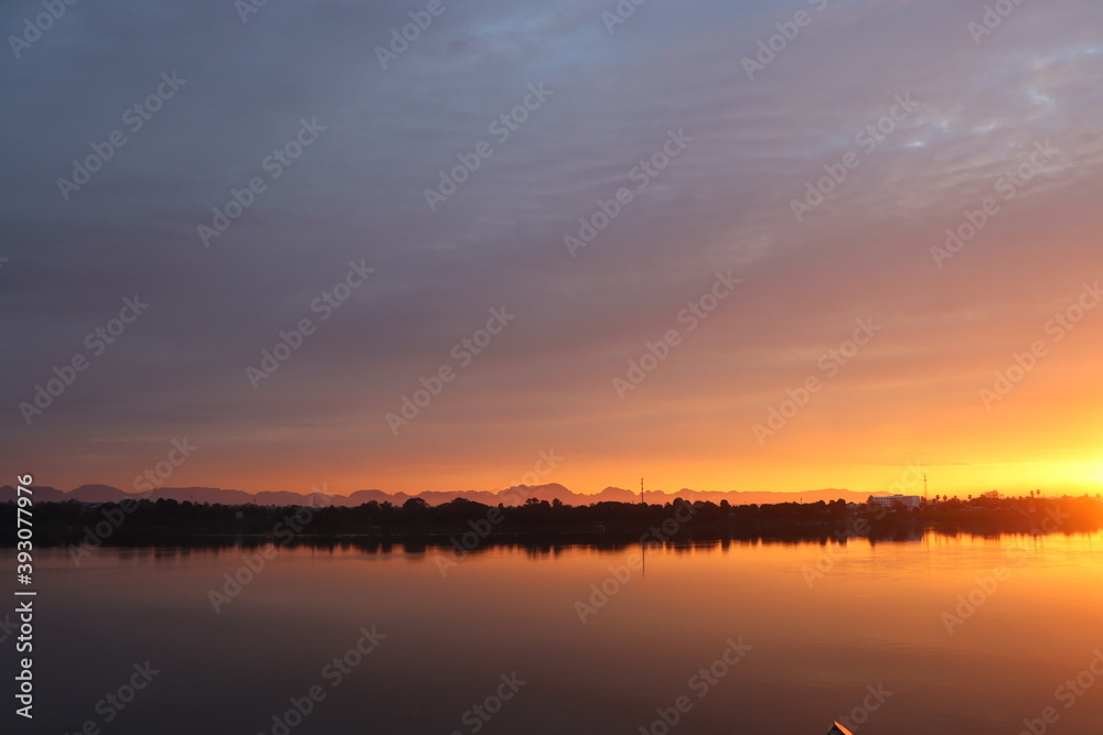 Long morning sunrise along the Mekong River bank