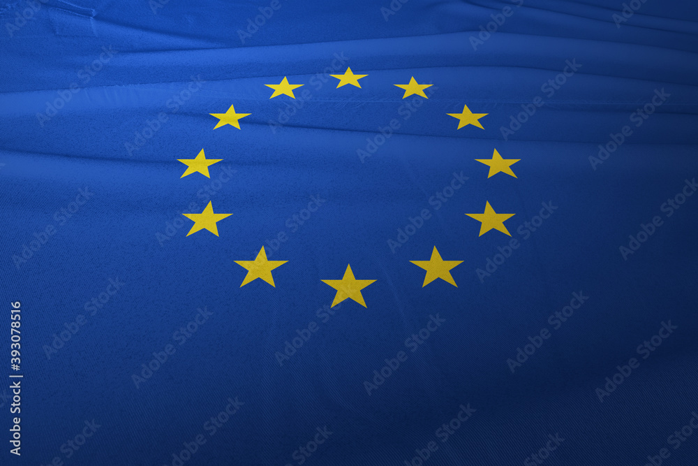 The European Union flag is flying in the air, the background is clouds and the blue sky The European Union flag is flying in the air, the background is clouds and the blue sky