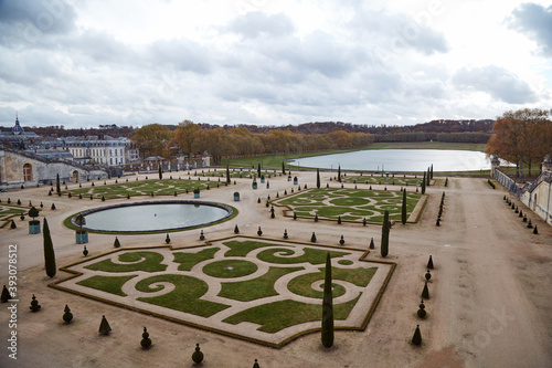 Versailles gardens with no visitors and people in autumn season.