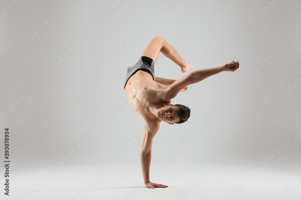 Flexible man dancing breakdance on one hand Flexible man dancing breakdance on one hand