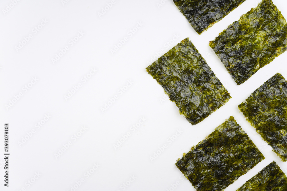 Fototapeta premium Nori chips on white background. Sushi, recipe, menu, seaweed, iodine concept. Top view, flat lay, copy space