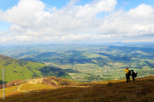 Tourists look at the world from the top of the Carpathian mountains