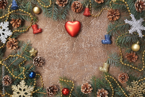 Christmas decorations, branches with cones, toys, on a brown background. With space for text. New year background.