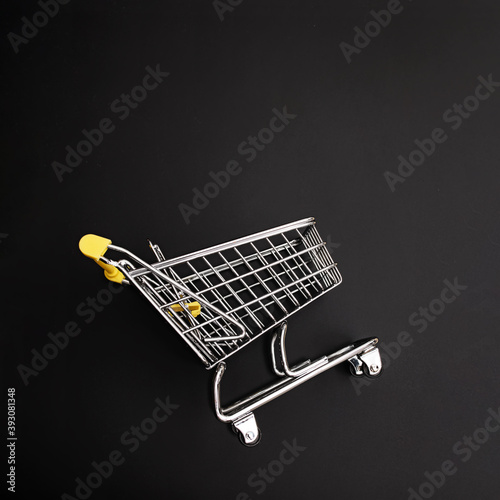 Mini shopping cart on black background