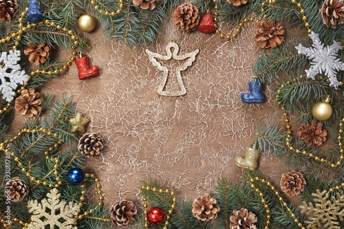 Christmas decorations, branches with cones, toys, on a brown background. With space for text. New year background.