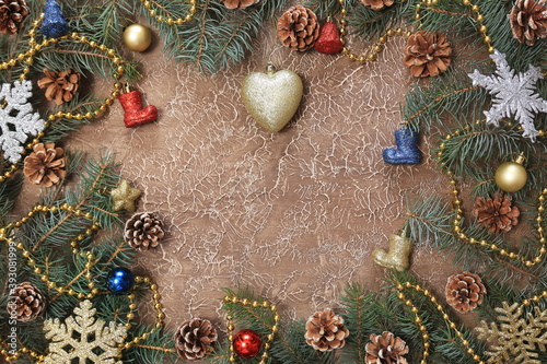 Christmas decorations, branches with cones, toys, on a brown background. With space for text. New year background.