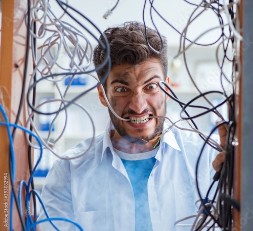 Computer repairman working on repairing network in IT workshop