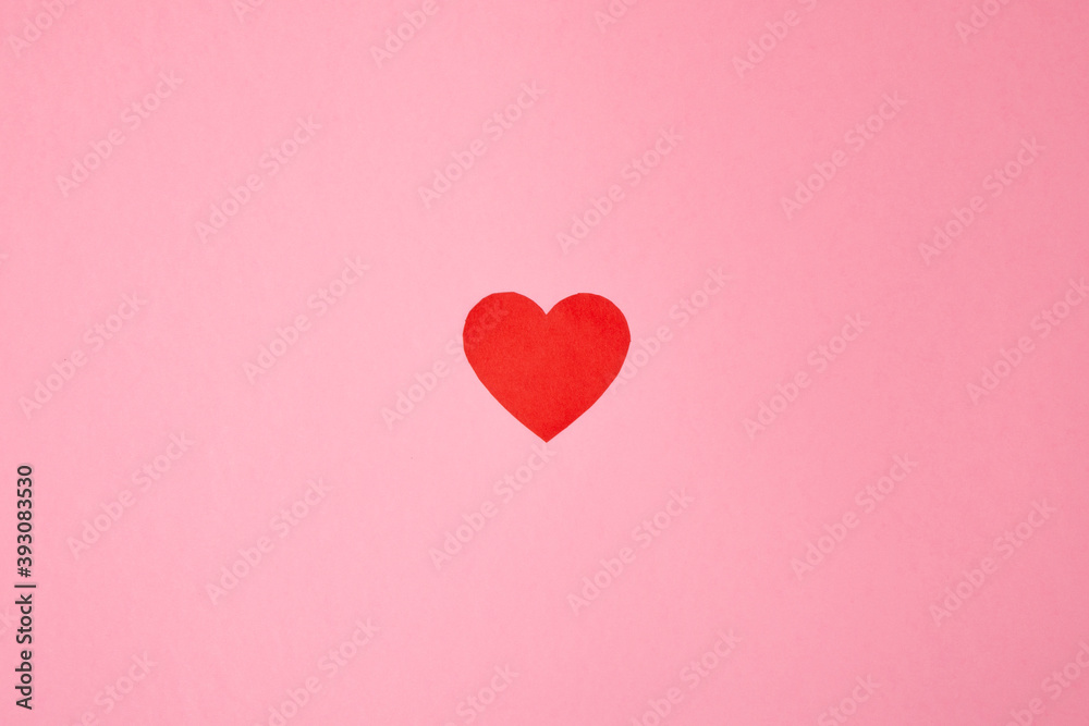 Overhead shot of a red heart on a pink background. Background for Valentine's day. Horizontal photography