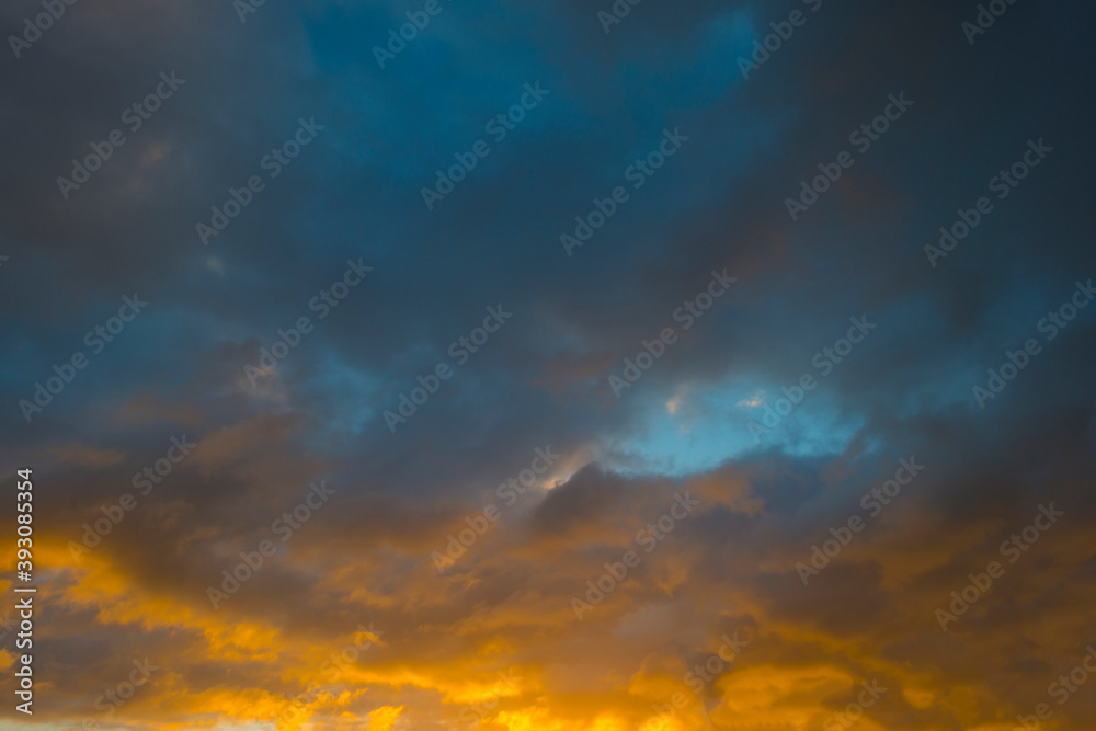 Colorful yellow grey clouds in a blue sky at sunrise in autumn, Almere, Flevoland, The Netherlands, November 16, 2020