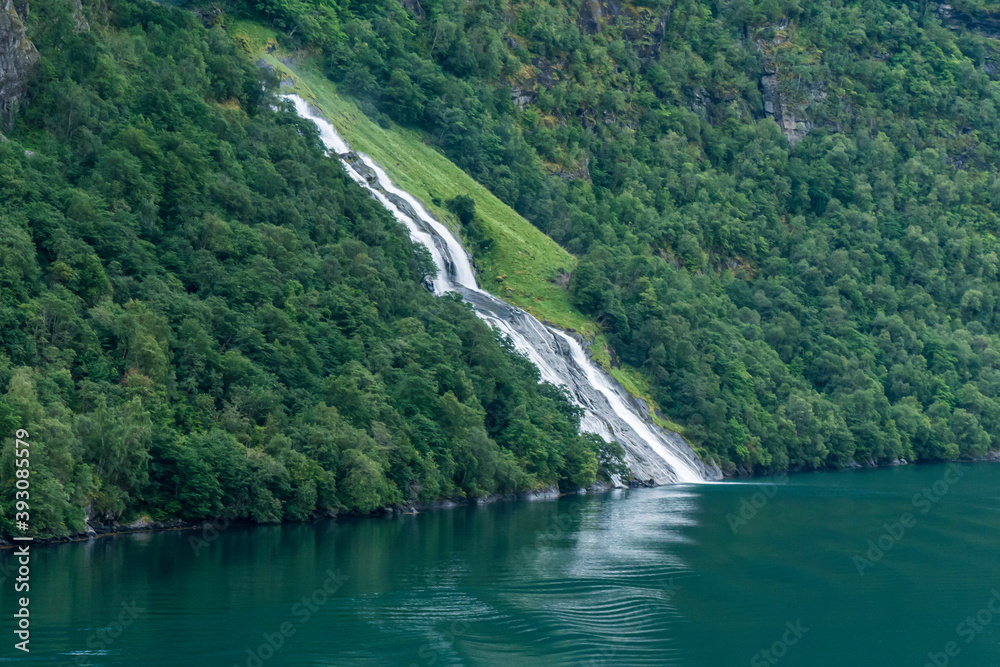 
large waterfall over a fjord in northern norway