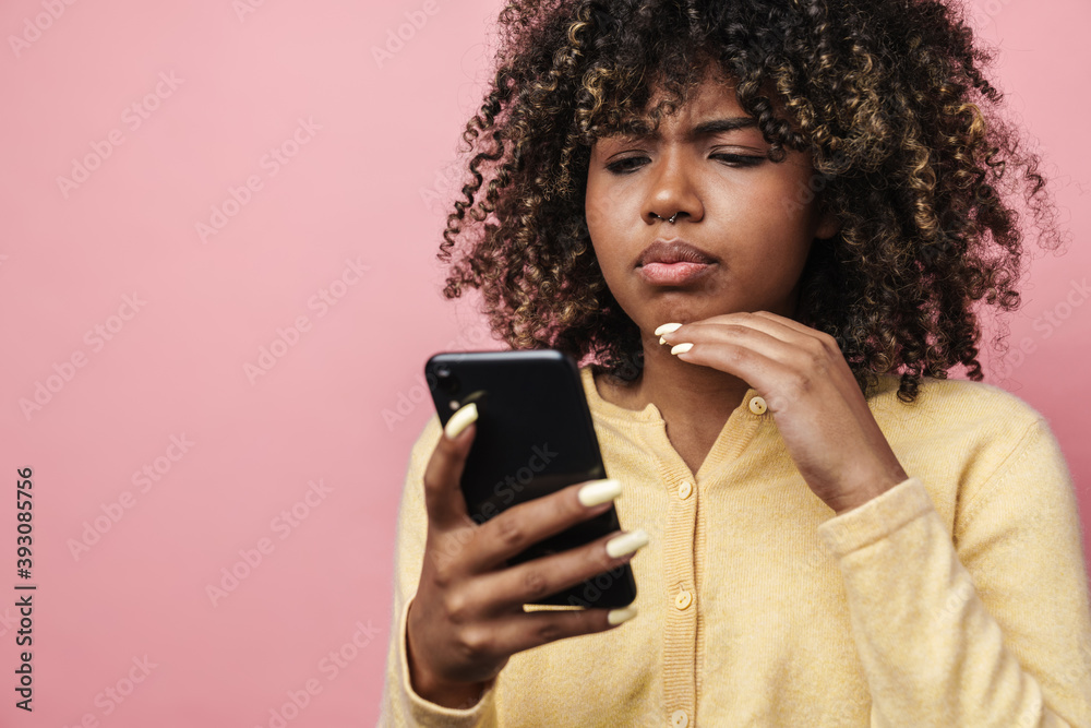 Brooding african american woman using mobile phone Brooding african american woman using mobile phone
