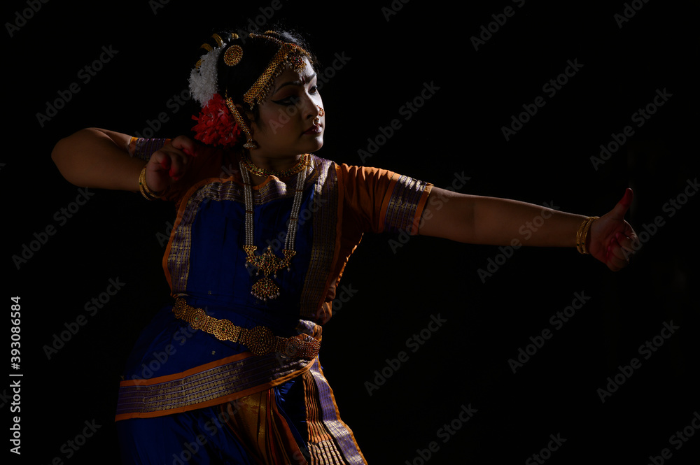 Kuchipudi dancer portraying an Archer holding a bow and arrow in her dance performance Kuchipudi dancer portraying an Archer holding a bow and arrow in her dance performance