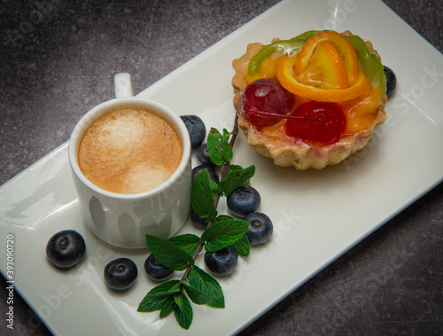 cup of coffee, pastry and berries of bow whortleberry