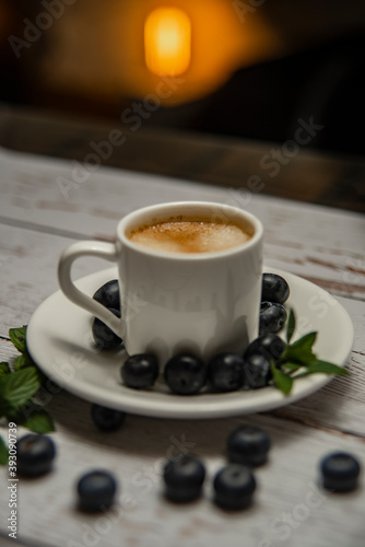 cup of coffee, pastry and berries of bow whortleberry