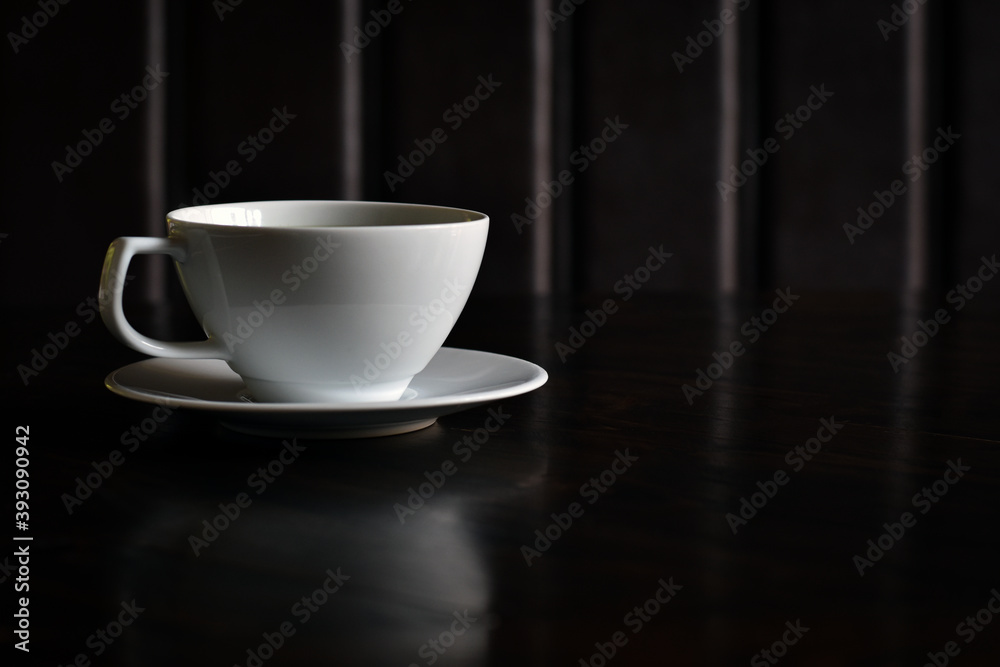Shadow background, White coffee cup on wooden table with copy space. Shadow background, White coffee cup on wooden table with copy space.