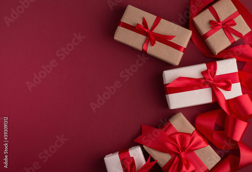 Boxing Day Sale concept with boxes tight with red bows, top view and empty copy space. © Hanna Aibetova