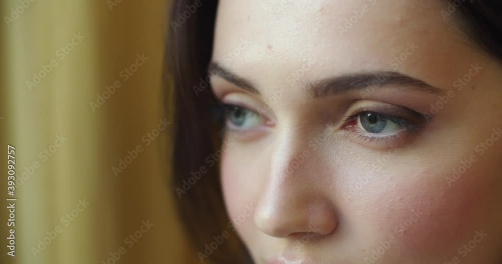 Detailed macro shot of female face looking afar with sad expression shallow handheld device. Close up portrait of pensive woman thinking of life problems slow motion. Skin care cosmetics make up Detailed macro shot of female face looking afar with sad expression shallow handheld device. Close up portrait of pensive woman thinking of life problems slow motion. Skin care cosmetics make up
