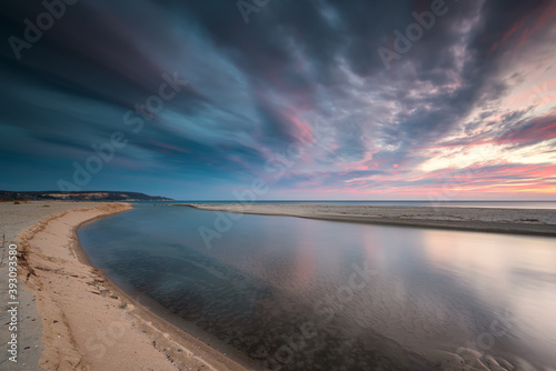 Amazing sunrise view with colorful reflections at the wild Black Sea coast and the mouth of the Kamchia River