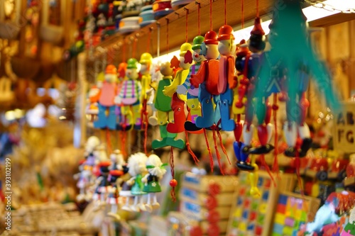 Wooden Toys and Decorations on Christmas Market in Winter Krakow, Poland. Advent Fair Decoration, and Stalls with Crafts Items in Bazaar. Street Xmas and holiday fair in European city. 