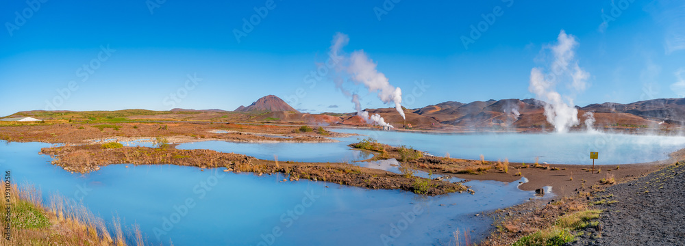 Panoramic view over geothermal active zones with power plants in Iceland, near Myvatn lake, summer and blue sky Panoramic view over geothermal active zones with power plants in Iceland, near Myvatn lake, summer and blue sky