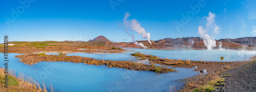 Panoramic view over geothermal active zones with power plants in Iceland, near Myvatn lake, summer and blue sky