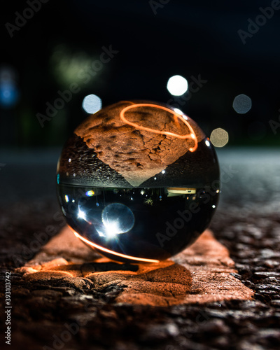 Lens ball placed on the road during the night photo