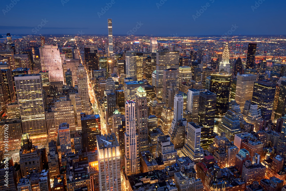 Obraz premium Aerial evening view of Midtown New York City skyline along Fifth Avenue. Illuminated Manhattan skyscrapers, NYC. USA