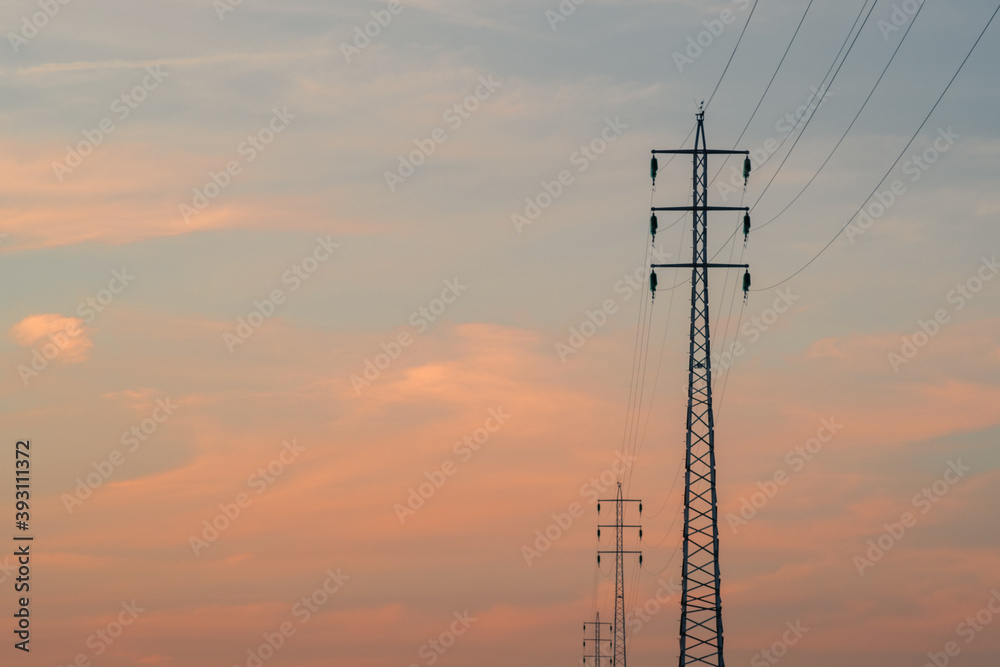 Low angle shot of transmission towers under a cloudy sky during a ...