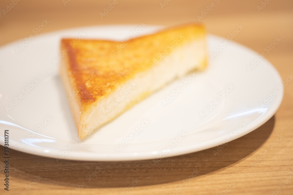 Triangle of garlic bread on white dish Triangle of garlic bread on white dish