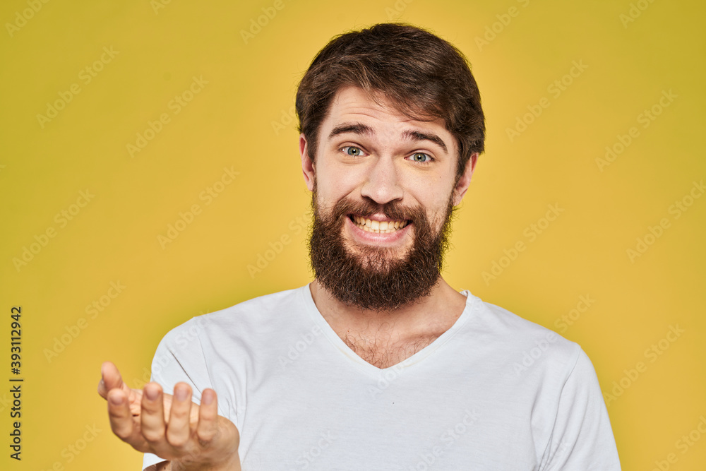 Fototapeta premium Bearded man in white t-shirt emotions close-up fun yellow background