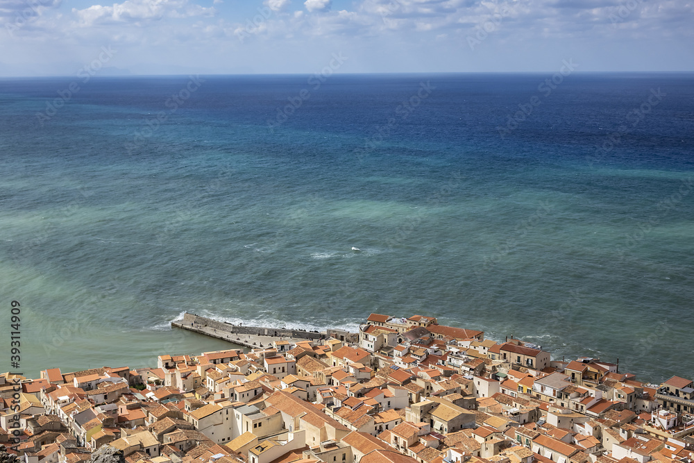 Panorama of Sicilian coastal medieval small city Cefalu (Cephaloedium) with turquoise Tyrrhenian Sea from Rocca Mountain. Province of Palermo, Cefalu, Sicily, Italy.