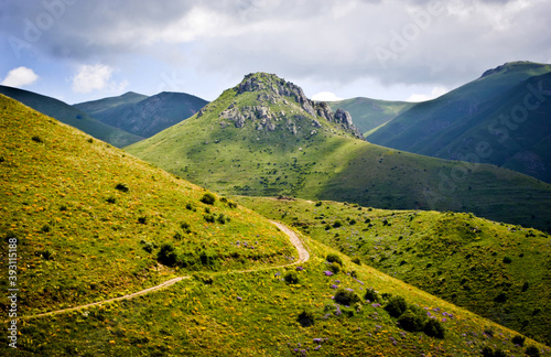 Фотография The road on the hillside leads to the medieval fortress