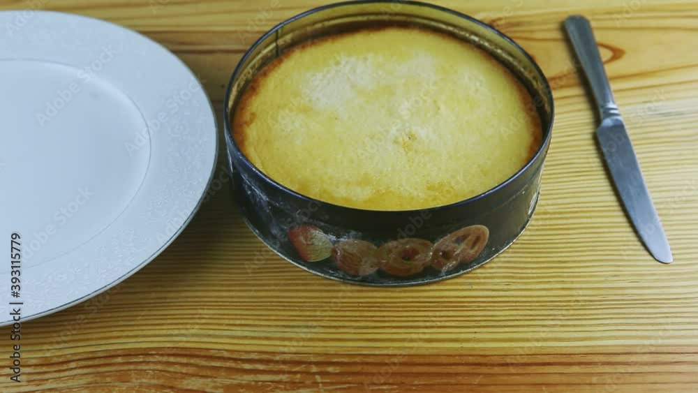 closeup view on round homemade flan in metal baking dish on wooden table closeup view on round homemade flan in metal baking dish on wooden table