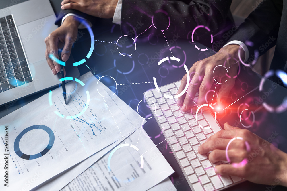 Man and woman working together on high tech project. Blue infographic abstract hologram drawings. Concept of future. Multiexposure. Man and woman working together on high tech project. Blue infographic abstract hologram drawings. Concept of future. Multiexposure.