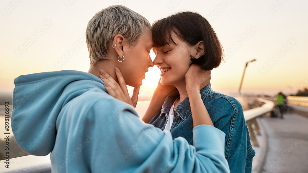 Two women smiling before kiss, Young lesbian couple enjoying romantic moments together at sunrise Two women smiling before kiss, Young lesbian couple enjoying romantic moments together at sunrise