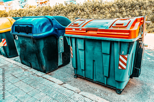 Variety dumpsters(recycling containers ) on a city street. photo