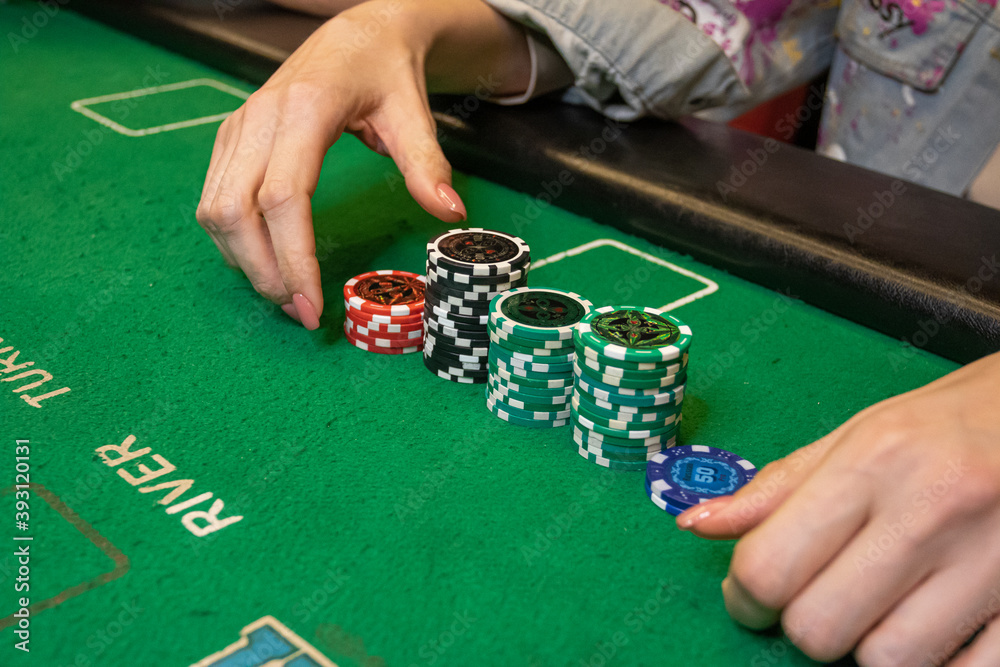 Poker game, the player is counting the chips on the table Poker game, the player is counting the chips on the table
